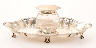Lot 447 - Early Geotge V silver ink stand of shaped form, with bead border, on four open work feet
