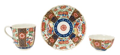Lot 203 - A Worcester trio, circa 1770, of fluted form, polychrome painted and gilded in the 'Rich Queens' pattern, pseudo-Chinese marks, the saucer 13.5cm diameter