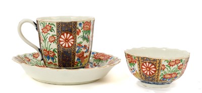 Lot 21 - Worcester trio, circa 1770, of fluted form, polychrome painted and gilded in the 'Rich Queens' pattern, pseudo-Chinese marks, the saucer 13.5cm diameter