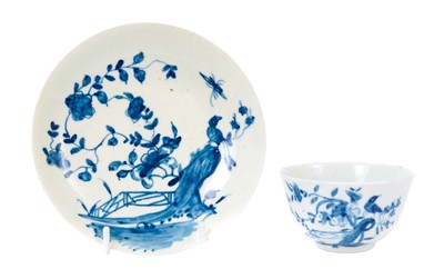 Lot 210 - A Worcester tea bowl and saucer, circa 1755-60, painted in underglaze blue with the 'Rock Warbler' pattern, workman's marks, the saucer 12.3cm diameter