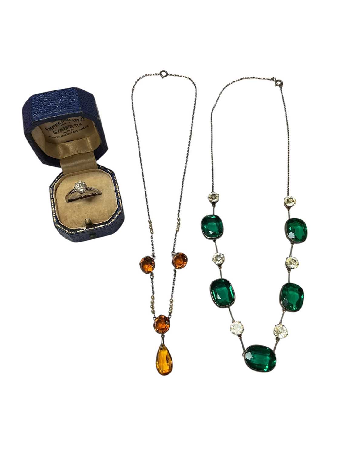 Lot 29 - Vintage green and white paste set pendant necklace in white metal setting and chain, one other orange paste set and seed pearl white metal necklace and a single synthetic white stone ring in whi...
