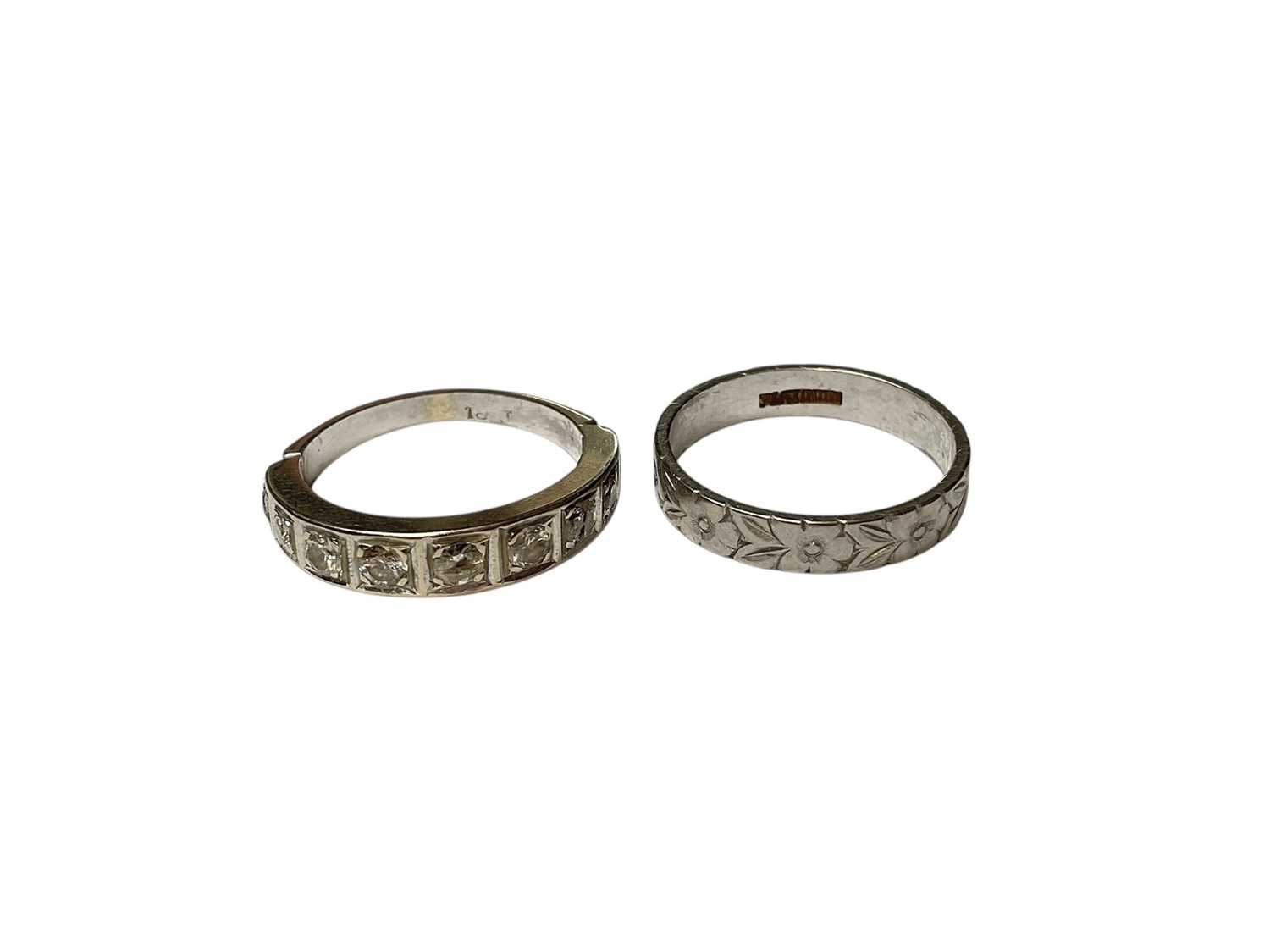 Lot 30 - 18ct white gold diamond nine stone half eternity ring and a platinum wedding ring with engraved floral decoration (2)