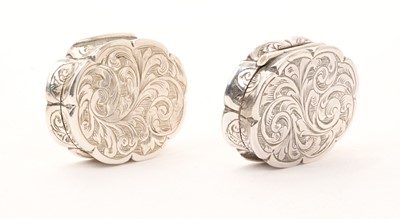 Lot 456 - Near pair of Victorian silver vinaigrettes of shaped form, with foliate engraved decoration
