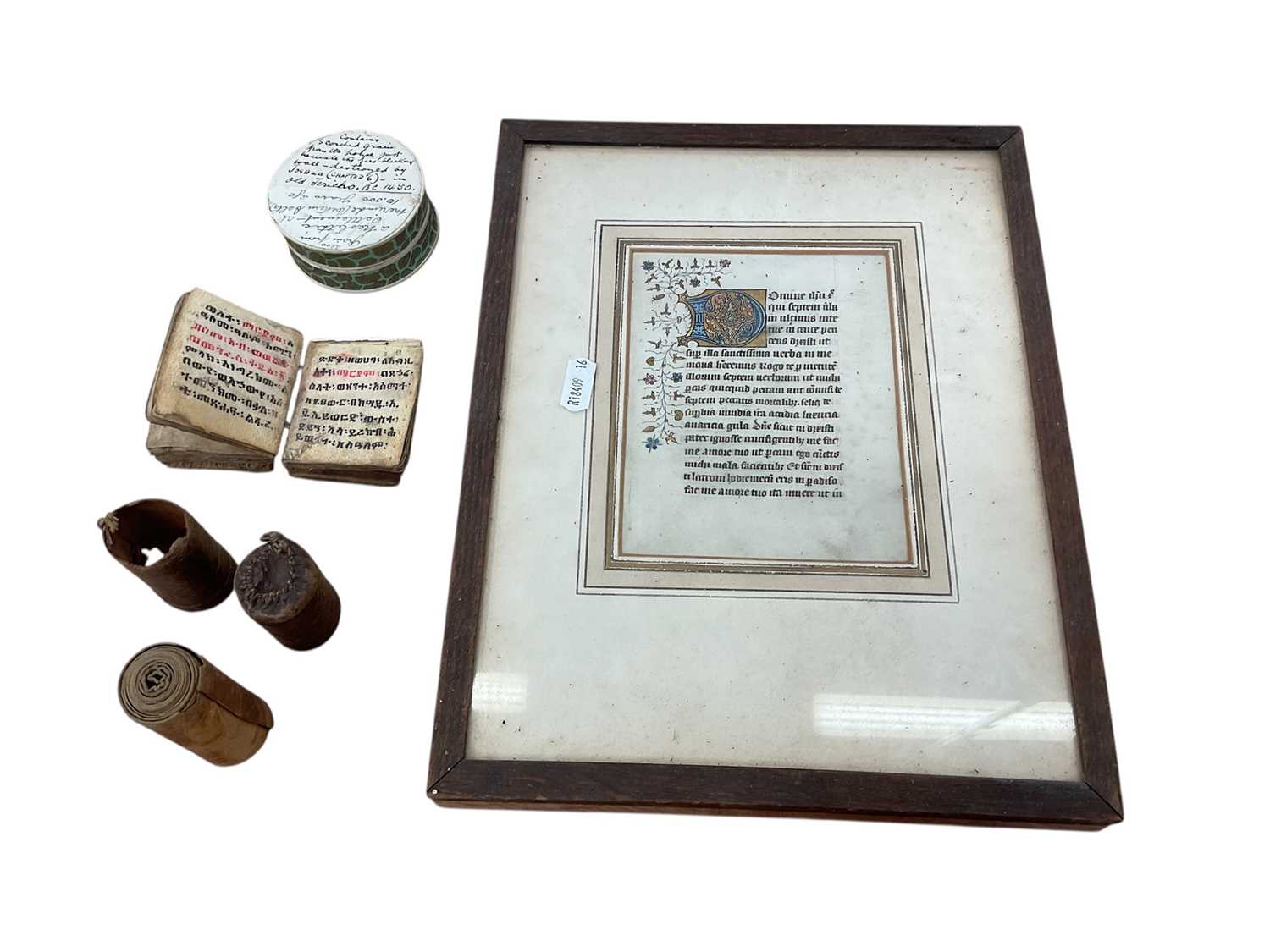 Lot 2417 - Group of items of religious interest, including a miniature holy book on vellum, written in an Abyssinian language and with old paper label, an Ethiopian healing scroll, and a framed manuscript...