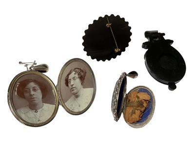 Lot 164 - Two Victorian silver oval lockets with engraved decoration, a Victorian gutta-percha pendant and brooch (4)