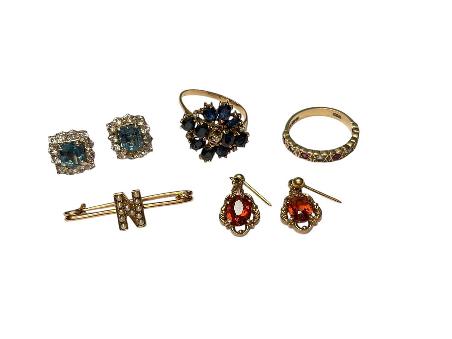 Lot 55 - Sapphire and diamond cluster ring in yellow metal setting, together with 9ct gold gem set half-eternity ring, two pairs 9ct gold gem set earrings and 9ct gold seed pearl 'N' initial bar brooch <...