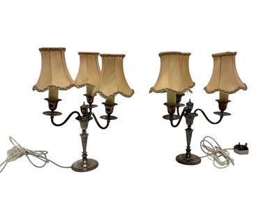 Lot 564 - Pair of silver three branch candledebra converted to lamps