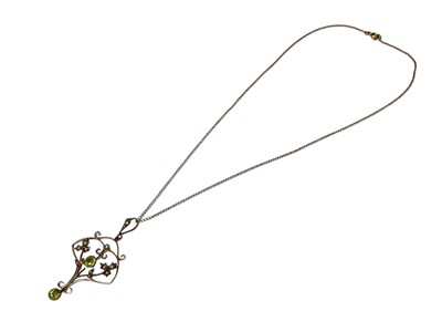Lot 60 - Edwardian 9ct gold peridot and seed pearl open work scroll pendant on 9ct gold chain