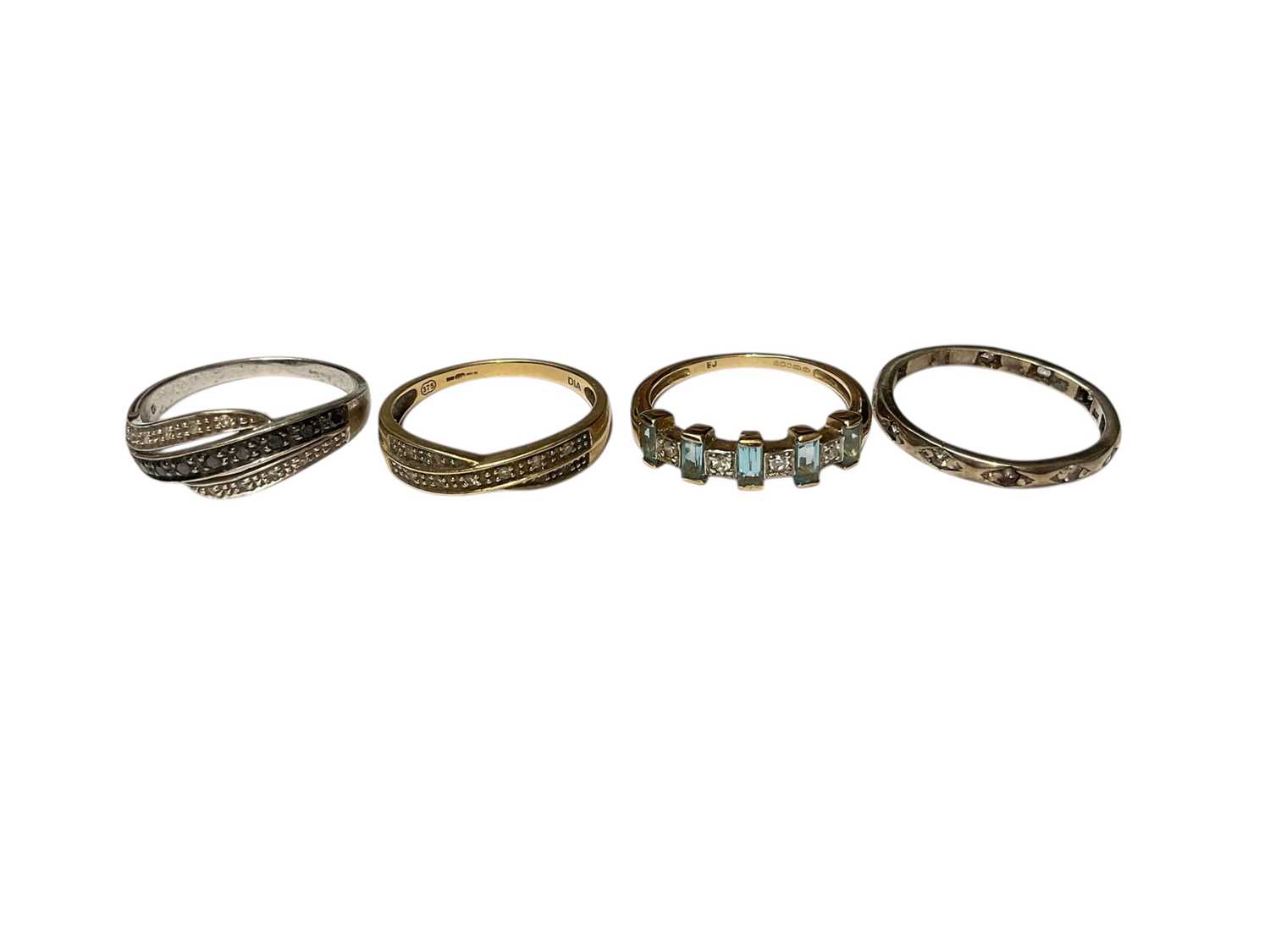 Lot 63 - Two 9ct gold diamond set cross over rings and two other 9ct gold gem set rings (4)