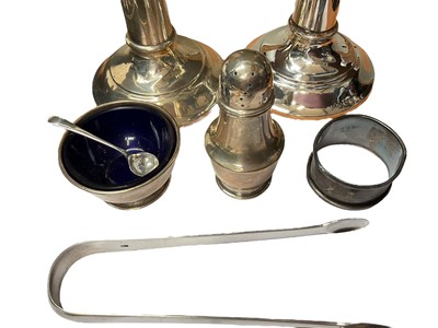 Lot 67 - Two similar silver candlesticks, set of six 1920s silver coffee bean end spoons in fitted case, set of six silver handled butter knives in fitted case, other silver items and flatware