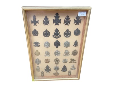 Lot 670 - Collection of thirty three various British Military cap badges to include Artists Rifles, London Rifle Brigade Cadets and East Surrey Regiment, mounted in glazed frame, (33).