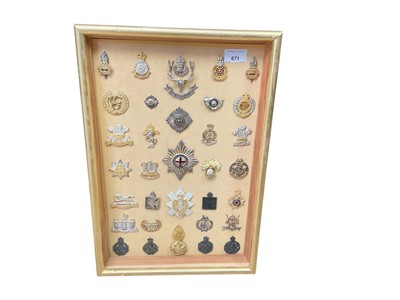 Lot 671 - Collection of thirty three various British Military cap badges to include Chaplins badges and Queen's Own Hussars, mounted in glazed frame and a bugle (34).