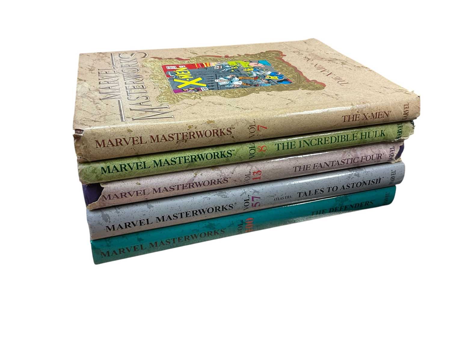 Lot 2857 - Five Marvel Masterworks - Vol 7 The X-Men, Vol 8 The Incredible Hulk, Vol 13 The Fantastic Four, Vol 57 Atlas Era Tales To Astonish and Vol 100 The Defenders
