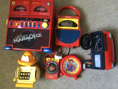 Lot 1997 - 1980's Sony red First Cassette player, Karioke and Walkman. Mario Brothers clock, 1980's Goast Busters backpack and Proton Pack, Binatone TV game boxed, Amiga Manual and other books, Guitar Hero...