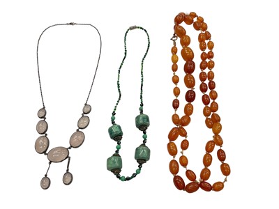 Lot 1188 - Amber bead necklace with graduated oval beads, 92cm long, silver mounted rose quartz necklace and one other necklace (3)