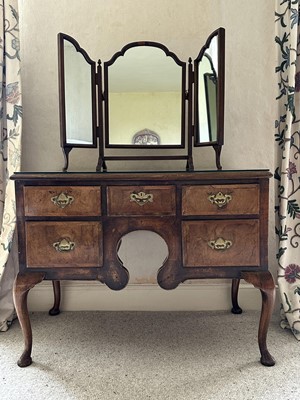 Lot 1273 - Queen Anne style walnut low boy/dressing table with an arrangement of five drawers, together with a triptych mirror