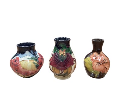 Lot 1015 - Three Moorcroft pottery vases including Forever England, 8.5cm high, Anna Lily, 10cm high and Hibiscus, 9.5cm high