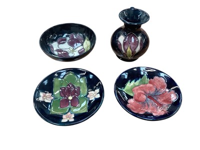 Lot 1018 - Four pieces of Moorcroft pottery to include vase, bowl and two pin dishes