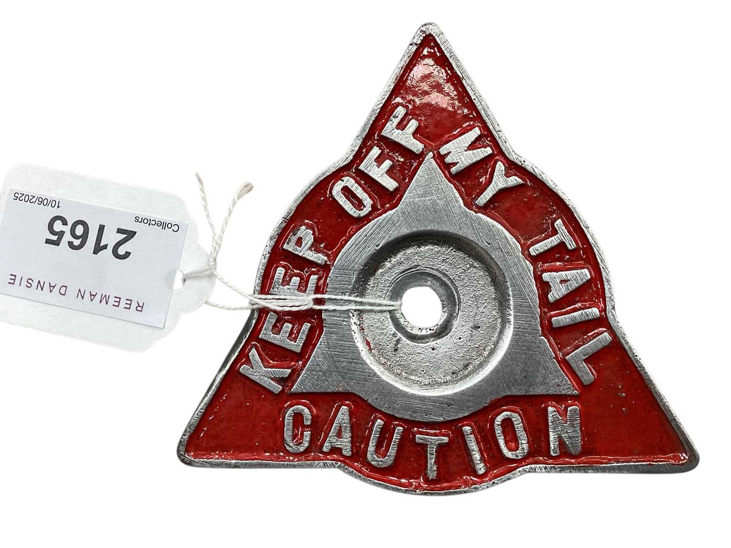 Lot 2165 - Vintage metal car badge 'Caution Keep off my tail', 9cm in length.