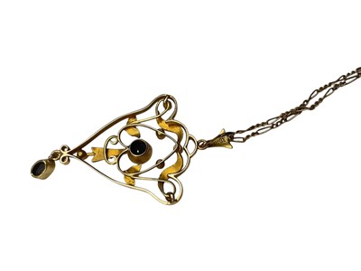 Lot 126 - Edwardian 15ct gold sapphire and seed pearl open work scroll pendant on a gold plated chain