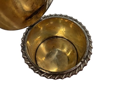 Lot 137 - Early Victorian silver mustard pot of drum form with gadrooned border, reeded angular handle and interior with blue glass liner, (London 1838), 5.1cm in overall height.