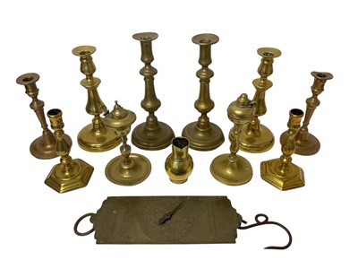 Lot 1105 - Antique brass and metalwork to include pair of bronze candlesticks with spun bases, two pairs of Georgian candlesticks with spun bases, 19th century bronze faced scale, pair of early brass stude...