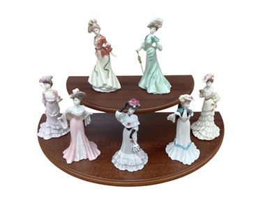 Lot 1066 - Seven Coalport figures - Lady Clara, Lady Emily, Lady Louise, Lady Evelyn, Lady May, Lady Sarah and Lady Beatrice, on a two tier stand