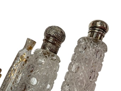 Lot 195 - Four Victorian and later cut glass scent bottles with silver mounts (various dates and makers), together with four continental glass scent bottles (8).