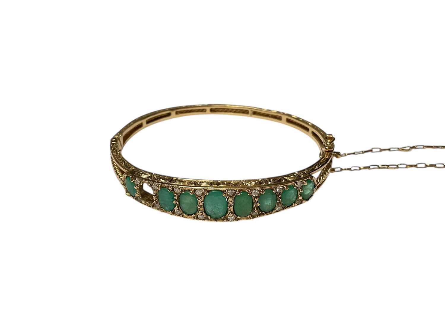 Lot 205 - 9ct gold emerald and diamond hinged bangle (one stone missing)