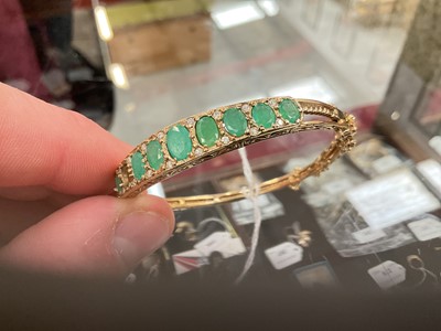 Lot 205 - 9ct gold emerald and diamond hinged bangle (one stone missing)