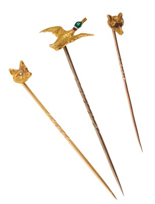 Lot 727 - Two gold fox mask stick pins and a gold flying duck stick pin