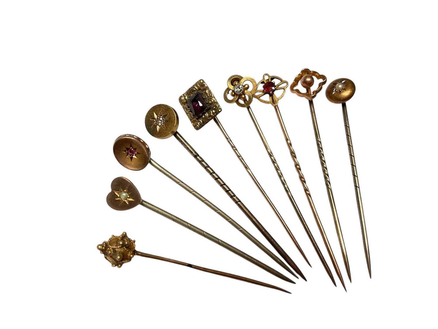 Lot 231 - Collection of nine Victorian and Edwardian gold and yellow metal gem set stick pins