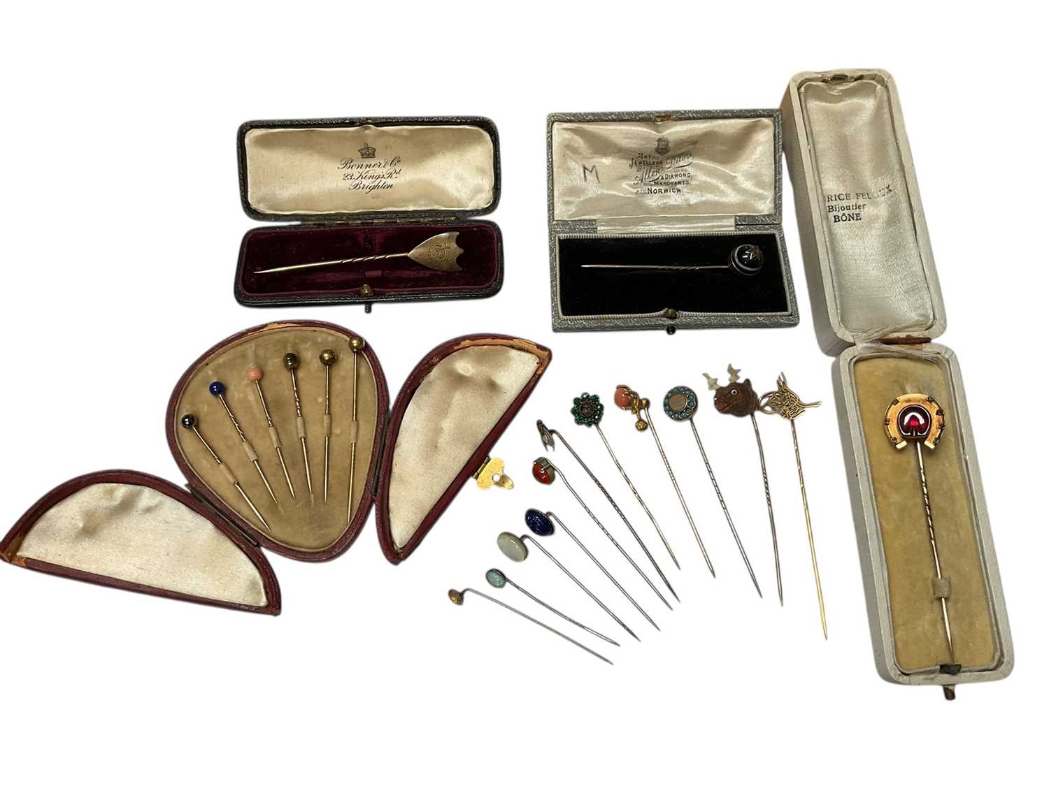 Lot 233 - Collection of antique and later stick pins including a diamond set red stone panel horseshoe, banded agate cabochon, paste set etc and a collection of various semi-precious stone sphere stick pi...