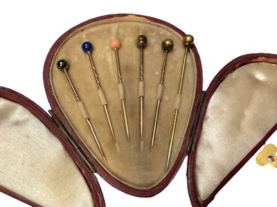 Lot 233 - Collection of antique and later stick pins including a diamond set red stone panel horseshoe, banded agate cabochon, paste set etc and a collection of various semi-precious stone sphere stick pi...