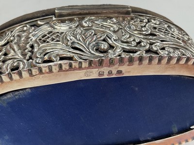 Lot 234 - Two Victorian silver mounted pin cushion jewellery boxes both with embossed scroll decoration, together with a smaller 1920s silver mounted pin cushion trinket box