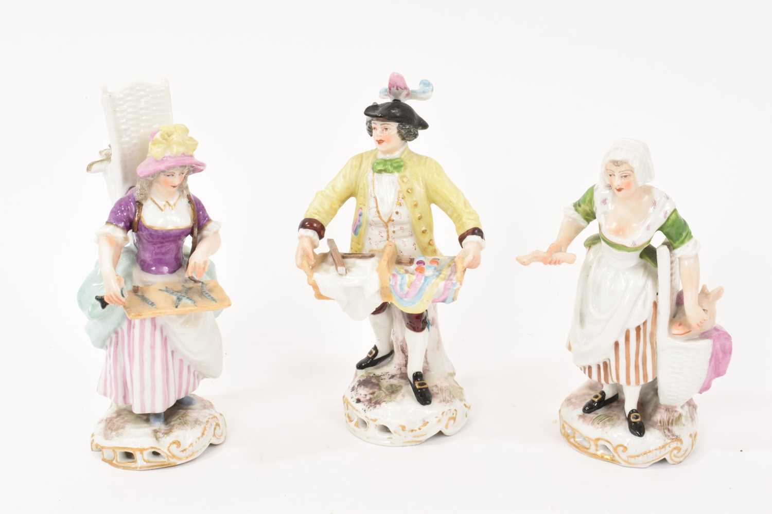 Lot 80 - Set of three Continental porcelain figures of street vendors, circa 1900