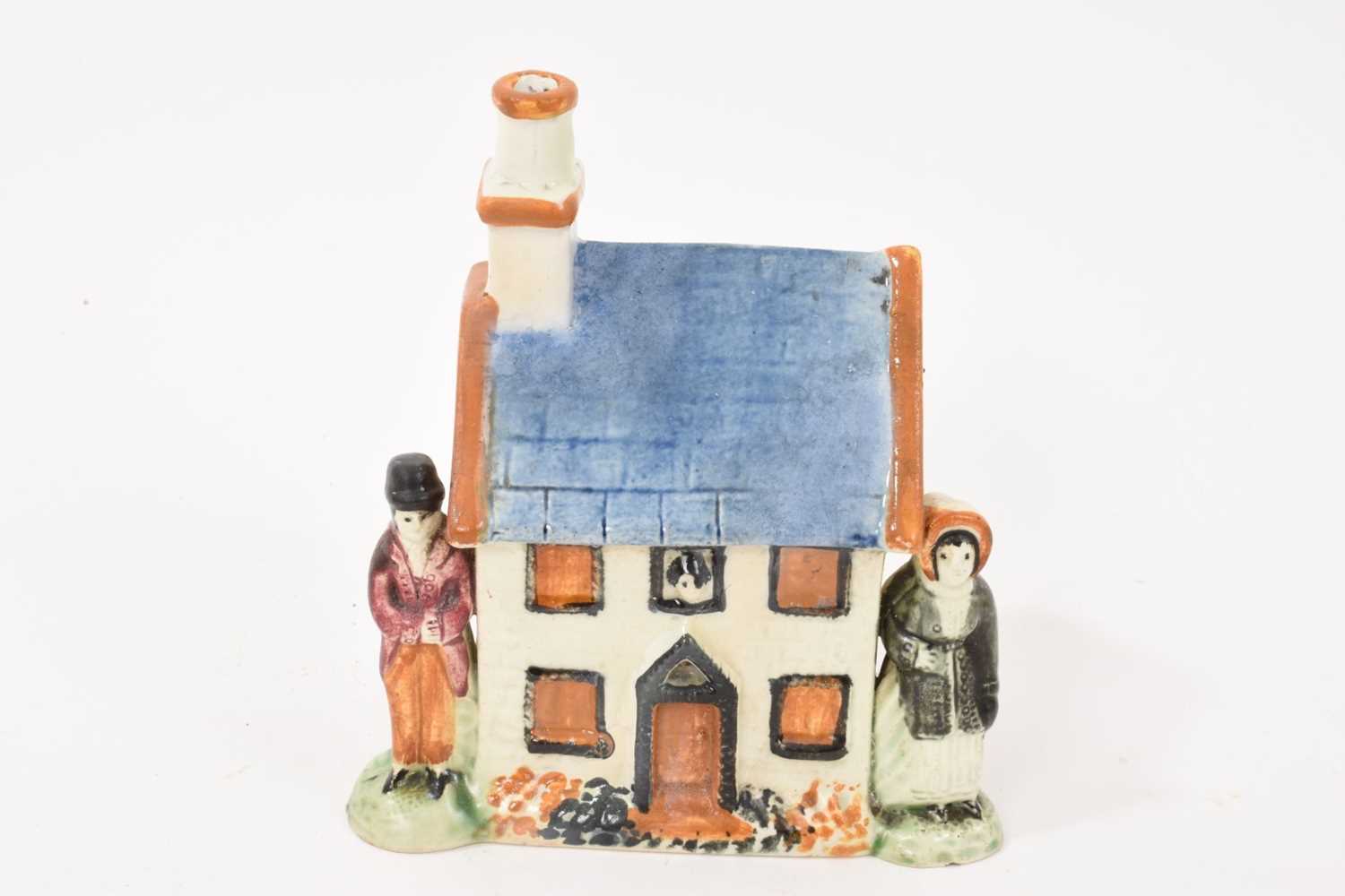 Lot 58 - Prattware type cottage shaped money box