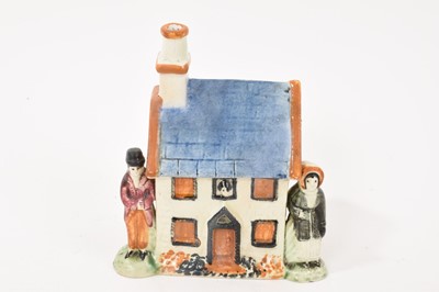 Lot 286 - Prattware type cottage shaped money box