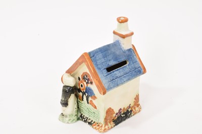 Lot 58 - Prattware type cottage shaped money box
