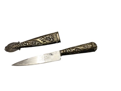 Lot 744 - South American Gaucho Knife / Dagger, steel blade by Pampa, in white metal scabbard with ornate scroll decoration , 29cm overall length.