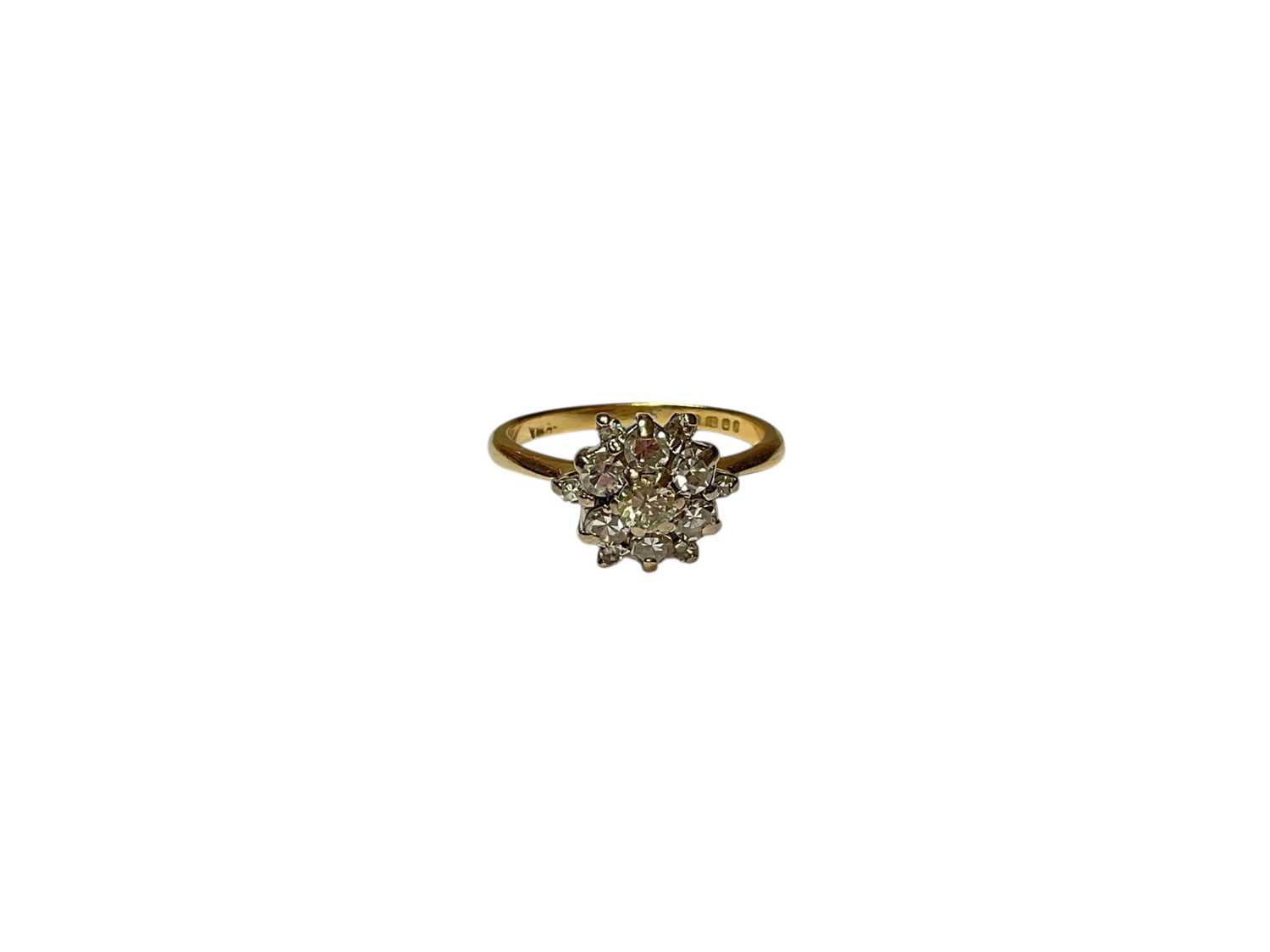 Lot 252 - Diamond flower head ring with a central brilliant cut diamond surrounded by six single cut diamonds and a further six smaller single c...