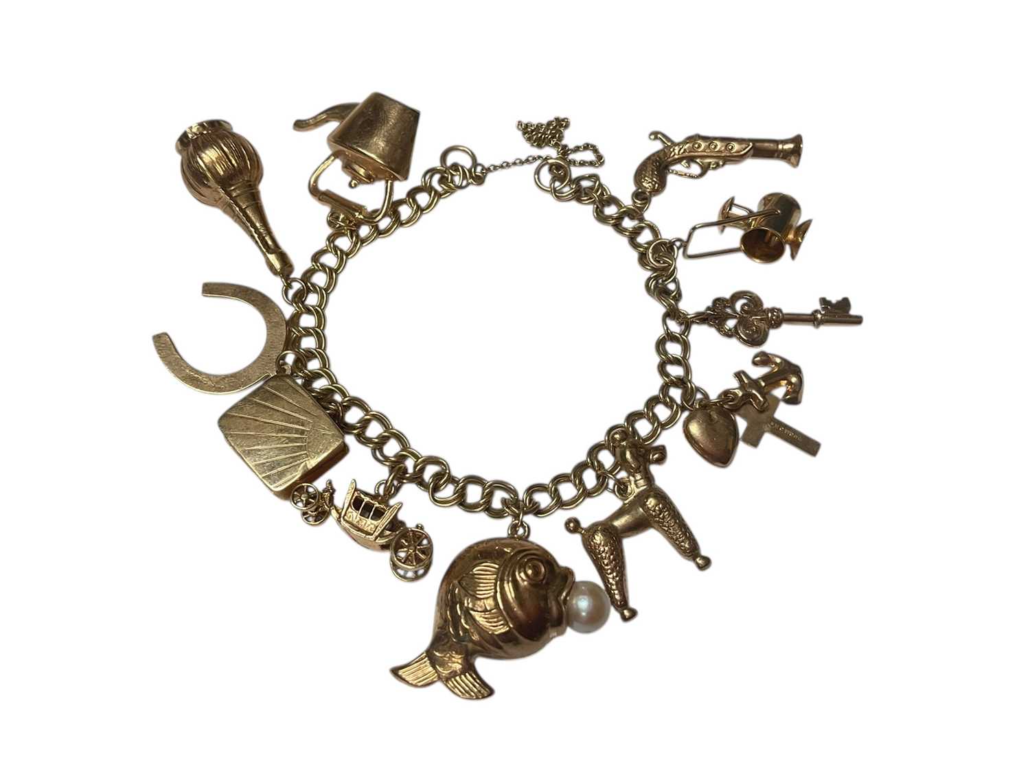 Lot 257 - 9ct gold charm bracelet with eleven gold and yellow metal novelty charms
