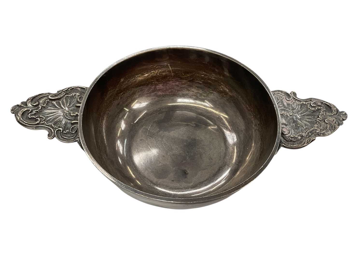Lot 270 - 19th century French silver porringer of circular form with twin handles, marked with Minervas head mark, 23cm in diameter (including handles), all at 9.5ozs.