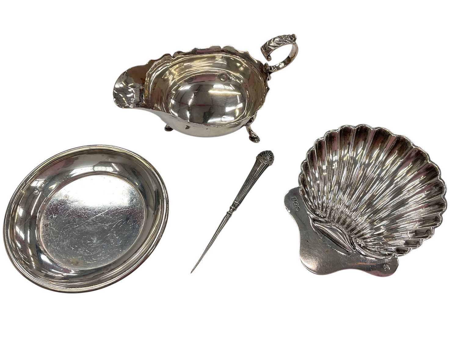 Lot 274 - Victorian silver sauce boat, together with a shell butter dish and another silver dish, (various dates and makers), all at approximately 8.5ozs