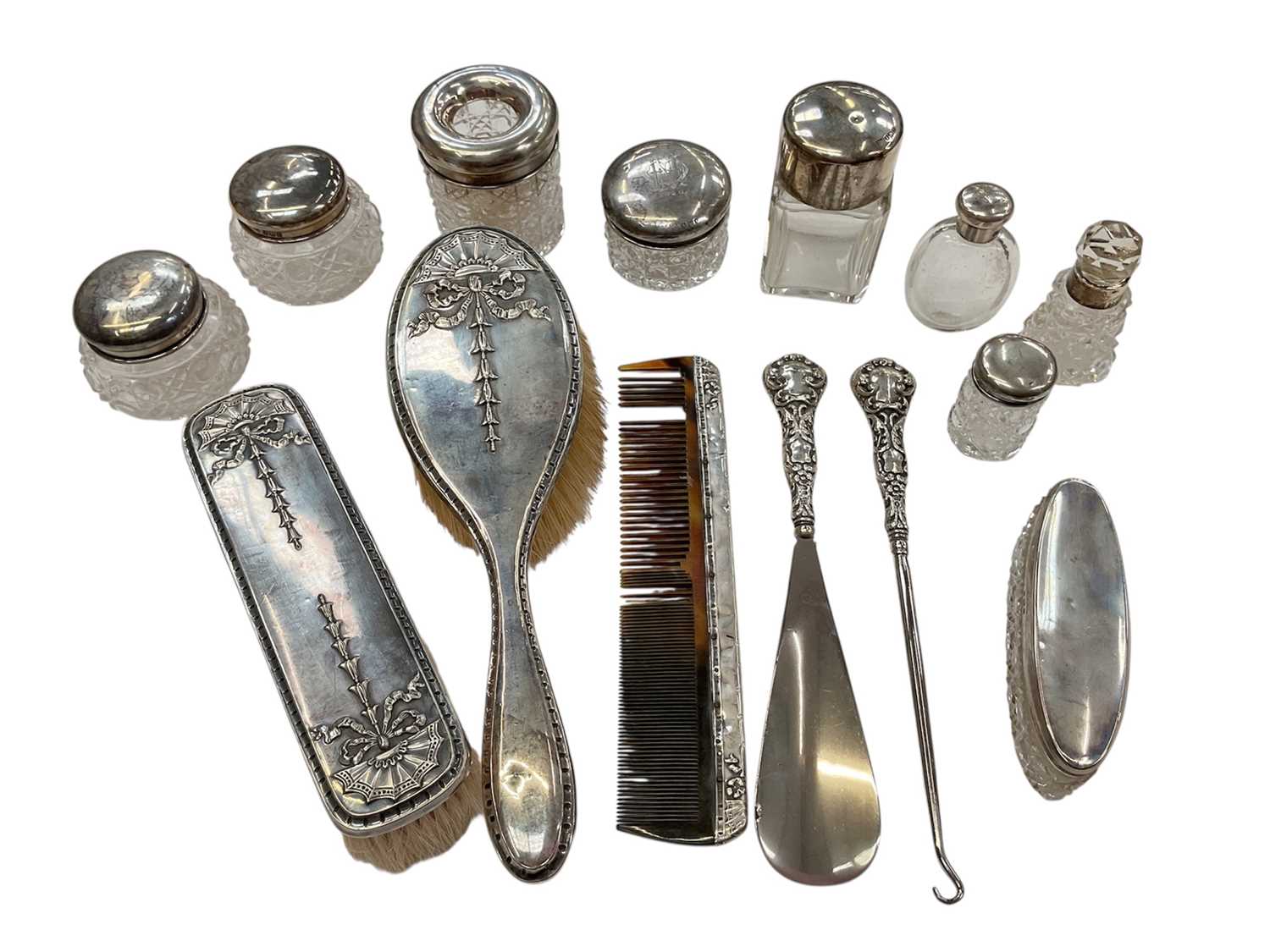 Lot 276 - Group of nine silver topped / mounted cut glass vanity jars and scent bottles, together with silver button hook, shoe horn, comb and two brushes (various dates and makers).