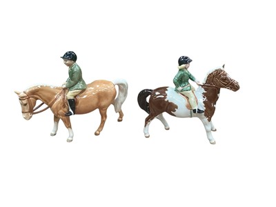 Lot 1114 - Beswick girl on a palomino horse, 13.5cm, and boy on a skewbald pony, 14cm (2)
