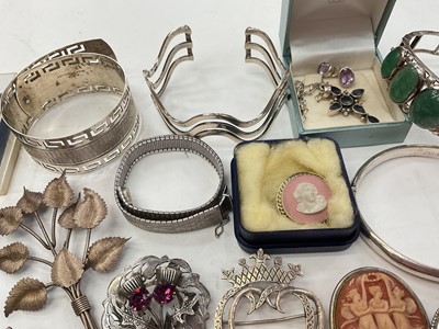Lot 281 - Group of silver and white metal jewellery including bangles, two Scottish brooches, other brooches, locket pendant on chain, semi-precious gem stone jewellery etc
