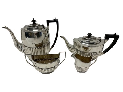 Lot 583 - Silver three piece tea set with half reeded body, together with a matching coffee pot. All at 53ozs