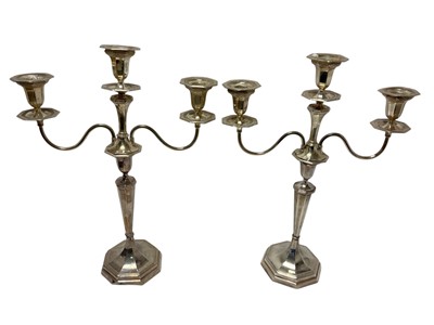 Lot 584 - Pair of silver twin branch candelabra