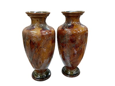 Lot 493 - Pair of Royal Doulton stoneware vases, decorated with leaves, each 32cm in overall height.
